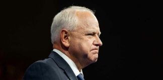 Elderly man in a suit looking determined.