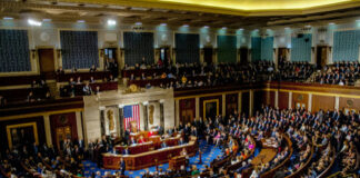 Congressional meeting in session with members seated in chambers.