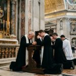 Catholic Officials BLINDSIDED By Trump’s Border Chief… Clergy members kneeling in prayer inside a grand cathedral
