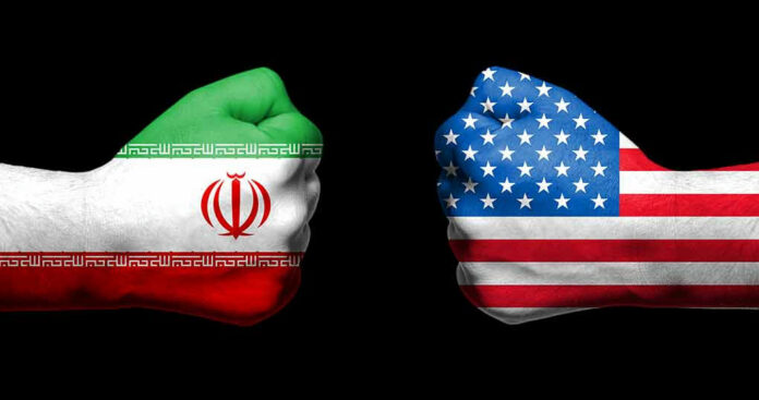 Two fists painted with Iran and USA flags.