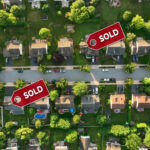 Massive Property Tax OVERHAUL – Governor STUNS NATION…. Aerial view of neighborhood with Sold signs on houses.
