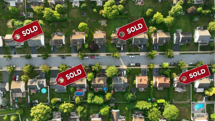 Aerial view of neighborhood with Sold signs on houses.