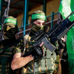 HAMAS Funds U.S. Schools — Unbelievable! Two armed masked soldiers with green flags.