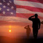 Army Vet SHATTERS 54-Year Record Live on TV… Silhouetted soldiers saluting against an American flag backdrop during sunset