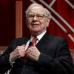 Mystery Billionaire Drops $9M on ONE Lunch… A distinguished man in a suit speaking at a conference