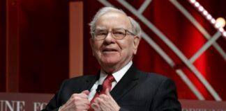A distinguished man in a suit speaking at a conference