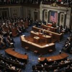 A large assembly of politicians in a legislative chamber