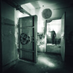 Apocalypse Paradise? Court DROPS Bombshell… A dark, abandoned room with a mysterious figure in the background