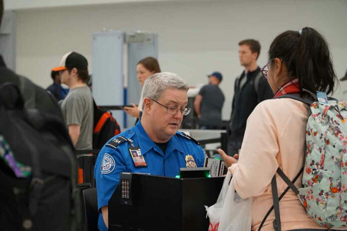 TSA agent checking a passengers documents at airport.