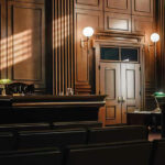 Raisin Empire Rocked by Heir’s Hate-Fueled Meltdown Empty courtroom with sunlight streaming through windows.