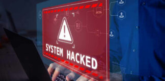 System Hacked warning on laptop screen.
