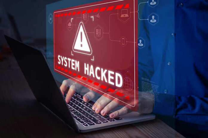 System Hacked warning on laptop screen.
