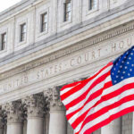 United States courthouse with American flag waving.