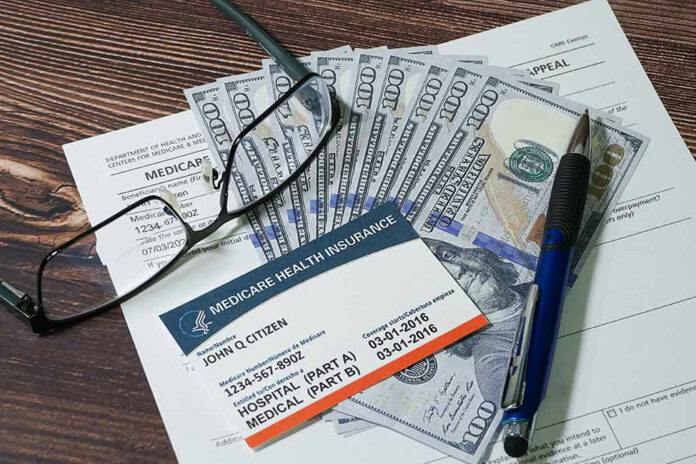 2248274327 Medicare card with cash, documents, glasses, and pen.