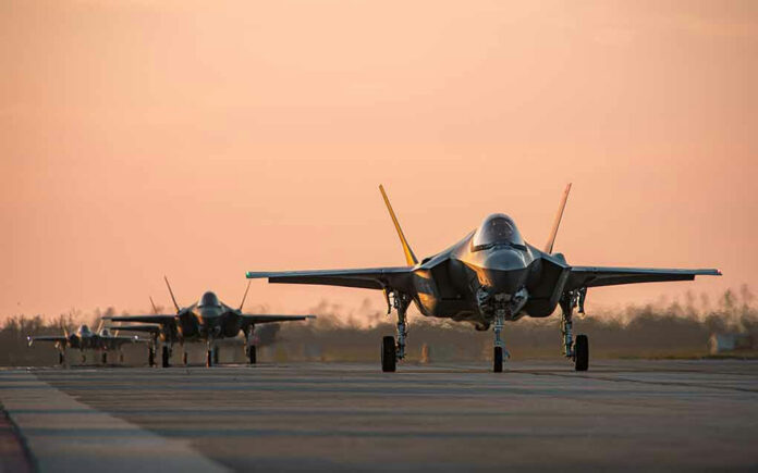 Jets on runway at sunset.