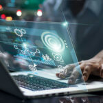 Court Disclosure Ties Grok AI to U.S. Strike Operations Person using laptop with futuristic data and analytics interface