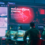 Military personnel monitor a command center screen showing missile launch alerts