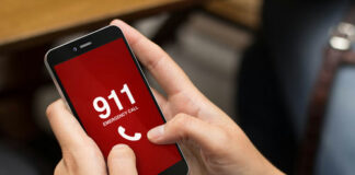 Person holding smartphone displaying emergency call screen