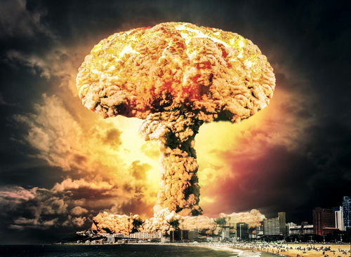Massive mushroom cloud over a coastal city skyline