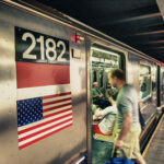 A busy subway platform with a train pulling in.