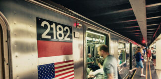 A busy subway platform with a train pulling in.