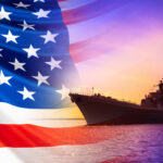 Gulf POWDER KEG — US Hits BACK! An American flag in the foreground with a naval ship silhouetted against a sunset