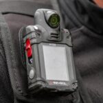 Close-up of a body camera attached to a persons shoulder