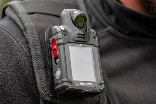 Close-up of a body camera attached to a persons shoulder