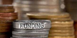 Stack of coins with the word funding engraved