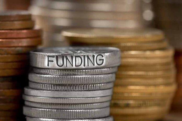 Stack of coins with the word funding engraved