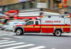 Woman BIRTHS Baby in the Middle of the Road! Red ambulance driving quickly through a city street.