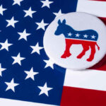 Rising Dem Star TRASHES U.S Flag During Rally USA flag and donkey button logo.