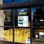 Store entrance with yellow shopping carts behind glass doors