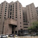 Brutalist high-rise building with narrow windows and angular facades