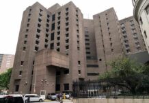Top Epstein Recruiter Found DEAD – Mysterious Circumstances Brutalist high-rise building with narrow windows and angular facades