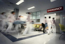 Medical staff rushing patient on stretcher in emergency room.