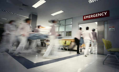 shutterstock_1675290874 Medical staff rushing patient on stretcher in emergency room.