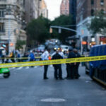 Psycho on the Run – Broad Daylight Rape Attack! Police officers behind yellow crime scene tape on city street.