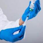 A healthcare professional preparing a syringe with a vaccine