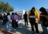 Students standing outside a high school entrance