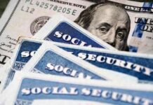 Government Sleepwalks Toward 22% Social Security Cut Social security cards and a hundred dollar bill arranged together