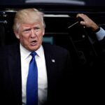 Trump Snags Golf TOP Position Says PGA man in suit stepping out of a vehicle