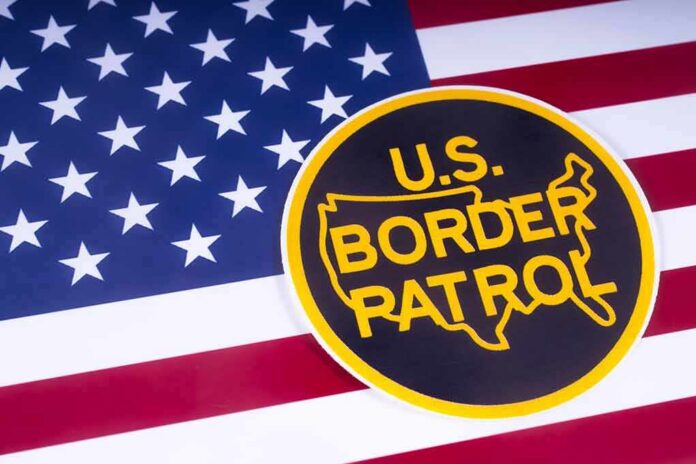shutterstock_1051372520-1 U.S. Border Patrol emblem on American flag
