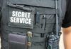 Tactical vest with Secret Service patch and gear