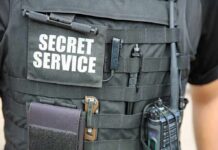 Tactical vest with Secret Service patch and gear