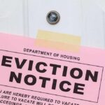 Eviction notice taped to a white door
