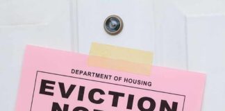 Eviction notice taped to a white door