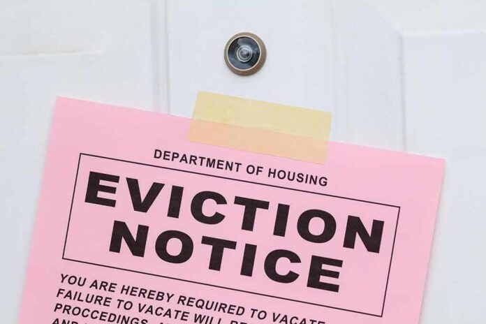 Eviction notice taped to a white door
