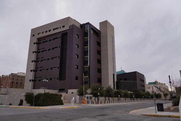Modern concrete and dark glass government building on a cloudy day