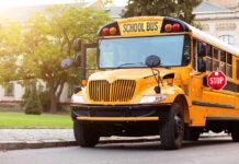Yellow school bus with stop sign extended